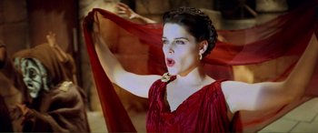 Movie still from “Scream 2” (1997), directed by Wes Craven – A woman in a red dress is holding a red cloth; Close Up shot, Low angle