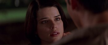 Movie still from “Scream 2” (1997), directed by Wes Craven – A woman that is looking at the camera; Close Up shot, Over the shoulder angle