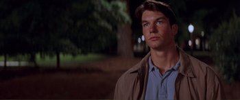 Movie still from “Scream 2” (1997), directed by Wes Craven – A man standing in the dark with a tree in the background; Close Up shot, Low angle