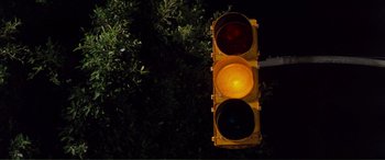 Movie still from “Scream 2” (1997), directed by Wes Craven – A traffic light sitting in the middle of the night; Extreme Close Up shot, Low angle