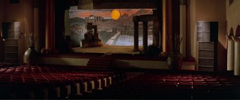 Movie still from “Scream 2” (1997), directed by Wes Craven – A stage with a large screen in the middle of the stage; Extreme Wide shot, High angle