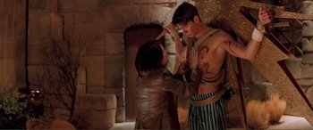 Movie still from “Scream 2” (1997), directed by Wes Craven – A man and a woman are tied to a wall; Medium shot, Over the shoulder angle