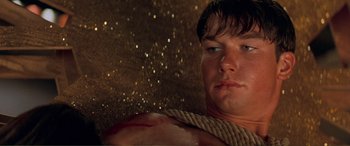 Movie still from “Scream 2” (1997), directed by Wes Craven – A man with a rope around his neck and chest; Close Up shot, Low angle