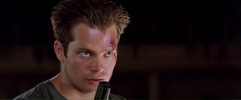 Movie still from “Scream 2” (1997), directed by Wes Craven – A person holding a gun; Close Up shot, Low angle