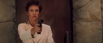 Movie still from “Scream 2” (1997), directed by Wes Craven – A woman in a white suit holding a gun in her hand; Close Up shot, Low angle
