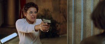 Movie still from “Scream 2” (1997), directed by Wes Craven – A woman in a white suit holding a gun in her hand; Close Up shot, Low angle