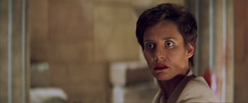 Movie still from “Scream 2” (1997), directed by Wes Craven – A person with short brown hair; Close Up shot, Over the shoulder angle