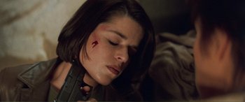 Movie still from “Scream 2” (1997), directed by Wes Craven – A person holding a gun with blood on it; Close Up shot, High angle