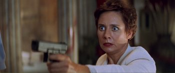 Movie still from “Scream 2” (1997), directed by Wes Craven – A person holding a tv remote control; Close Up shot, High angle