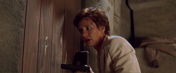 Movie still from “Scream 2” (1997), directed by Wes Craven – A woman holding a cell phone in her hand; Close Up shot, Low angle