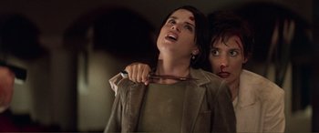 Movie still from “Scream 2” (1997), directed by Wes Craven – A woman holding a pair of scissors in her hand; Close Up shot, Low angle