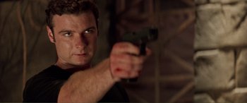 Movie still from “Scream 2” (1997), directed by Wes Craven – A person holding a gun; Close Up shot, Over the shoulder angle