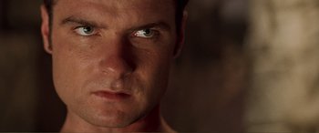 Movie still from “Scream 2” (1997), directed by Wes Craven – A man's face with green eyes; Close Up shot, Low angle