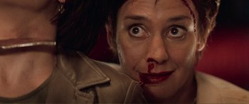 Movie still from “Scream 2” (1997), directed by Wes Craven – A person with blood on her face; Close Up shot, High angle