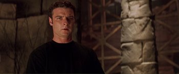 Movie still from “Scream 2” (1997), directed by Wes Craven – A person wearing a black t - shirt; Close Up shot, Low angle