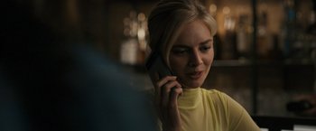 Movie still from “Scream VI” (2023), directed by Matt Bettinelli-Olpin – A beautiful blonde woman talking on a cell phone; Close Up shot, Over the shoulder angle