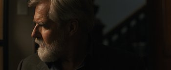 Movie still from “Scream VI” (2023), directed by Matt Bettinelli-Olpin – A person with a beard; Close Up shot, Over the shoulder angle