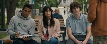 Movie still from “Scream VI” (2023), directed by Matt Bettinelli-Olpin – A woman sitting on a bench next to two other people; Medium shot, Over the shoulder angle