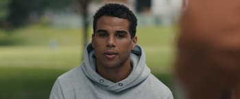 Movie still from “Scream VI” (2023), directed by Matt Bettinelli-Olpin – A person wearing a hooded sweatshirt; Close Up shot, Over the shoulder angle