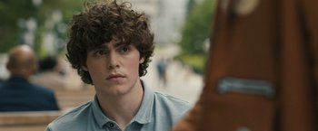 Movie still from “Scream VI” (2023), directed by Matt Bettinelli-Olpin – A young man is looking into the distance; Close Up shot, Over the shoulder angle