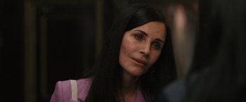 Movie still from “Scream VI” (2023), directed by Matt Bettinelli-Olpin – A person with long black hair; Close Up shot, Over the shoulder angle