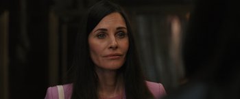 Movie still from “Scream VI” (2023), directed by Matt Bettinelli-Olpin – A person with long black hair; Close Up shot, Over the shoulder angle