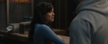 Movie still from “Scream VI” (2023), directed by Matt Bettinelli-Olpin – A woman sitting at a table looking to her left; Close Up shot, Over the shoulder angle