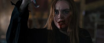 Movie still from “Scream VI” (2023), directed by Matt Bettinelli-Olpin – A person with blood on their face; Close Up shot, Over the shoulder angle