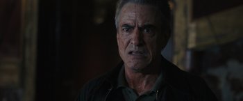 Movie still from “Scream VI” (2023), directed by Matt Bettinelli-Olpin – An older man with a beard and a mustache; Close Up shot, Over the shoulder angle