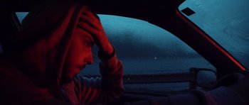Movie still from “Seaspiracy” (2021), directed by Ali Tabrizi – A person sitting in a car looking out of the window; Close Up shot, Low angle