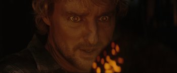 Movie still from “Secret Headquarters” (2022), directed by Henry Joost – A man's eyes with a flame in the background; Extreme Close Up shot, Over the shoulder angle