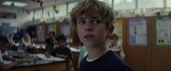 Movie still from “Secret Headquarters” (2022), directed by Henry Joost – A young boy is looking into the distance; Close Up shot, Over the shoulder angle