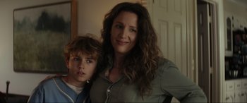 Movie still from “Secret Headquarters” (2022), directed by Henry Joost – A woman standing next to a young boy in front of a door; Close Up shot, Low angle