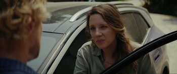 Movie still from “Secret Headquarters” (2022), directed by Henry Joost – A woman sitting in the driver's seat of a car; Close Up shot, Over the shoulder angle