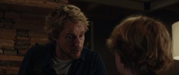 Movie still from “Secret Headquarters” (2022), directed by Henry Joost – A man with blonde hair is looking at another man in a room; Close Up shot, Over the shoulder angle