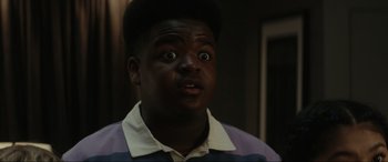 Movie still from “Secret Headquarters” (2022), directed by Henry Joost – A man with a surprised look on his face; Close Up shot, Low angle