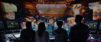 Movie still from “Secret Headquarters” (2022), directed by Henry Joost – A group of people standing in front of a screen; Medium shot, Over the shoulder angle