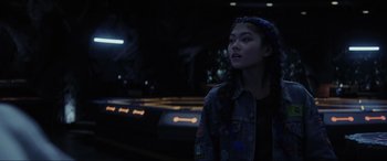 Movie still from “Secret Headquarters” (2022), directed by Henry Joost – A young girl is standing in a dark room; Close Up shot, Over the shoulder angle