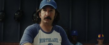 Movie still from “Secret Headquarters” (2022), directed by Henry Joost – A person wearing a baseball cap; Close Up shot, Over the shoulder angle