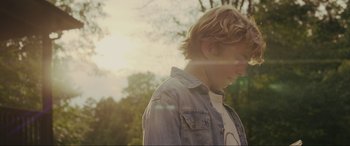 Movie still from “Secret Headquarters” (2022), directed by Henry Joost – A young boy is standing in the sunlight; Close Up shot, Low angle