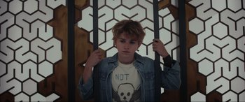 Movie still from “Secret Headquarters” (2022), directed by Henry Joost – A young man standing in front of a wall; Close Up shot, Low angle