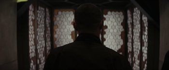 Movie still from “Secret Headquarters” (2022), directed by Henry Joost – A man standing in front of a wall with lights on it; Close Up shot, Over the shoulder angle