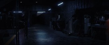 Movie still from “Secret Headquarters” (2022), directed by Henry Joost – A dark room with lights on the wall; Extreme Wide shot, High angle
