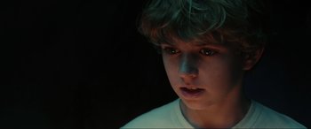 Movie still from “Secret Headquarters” (2022), directed by Henry Joost – A young boy is looking into the dark; Close Up shot, High angle
