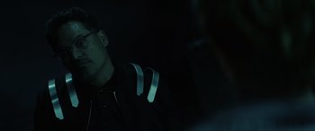 Movie still from “Secret Headquarters” (2022), directed by Henry Joost – A man with a pair of headphones in his ear; Close Up shot, Over the shoulder angle
