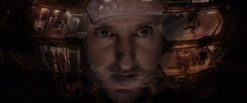 Movie still from “Secret Headquarters” (2022), directed by Henry Joost – A man's face with a lot of different images behind it; Extreme Close Up shot, Overhead angle