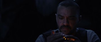 Movie still from “Secret Headquarters” (2022), directed by Henry Joost – A person lighting a cigarette in the dark; Close Up shot, Overhead angle