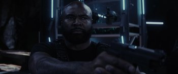 Movie still from “Secret Headquarters” (2022), directed by Henry Joost – A man with a bald head is looking at the camera; Close Up shot, Low angle