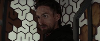 Movie still from “Secret Headquarters” (2022), directed by Henry Joost – A person with a beard; Close Up shot, Over the shoulder angle