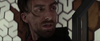 Movie still from “Secret Headquarters” (2022), directed by Henry Joost – A person with long hair and a beard; Close Up shot, Over the shoulder angle